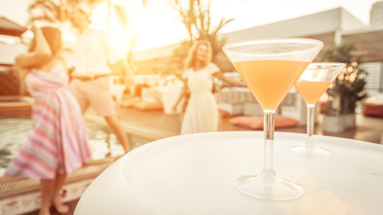Martini cocktails on table with people dancing in California