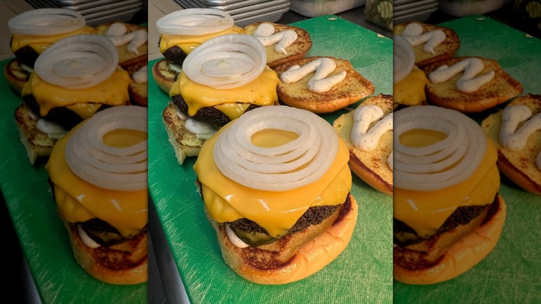 cheeseburgers being made in a row at Moo's Craft Barbecue