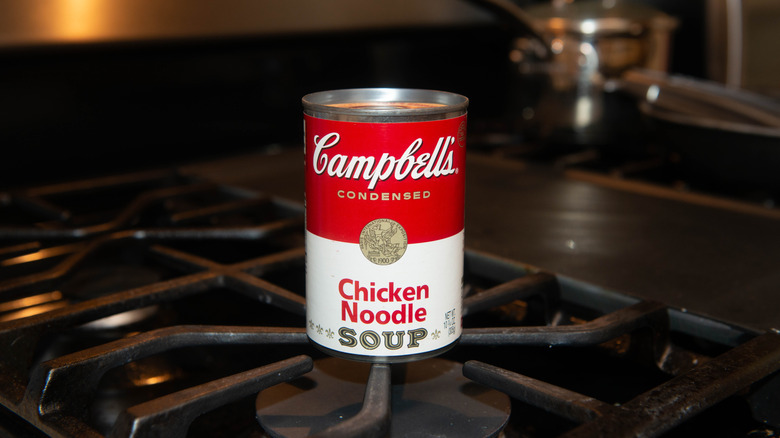 A can of Campbell's Chicken Noodle Soup on a stovetop