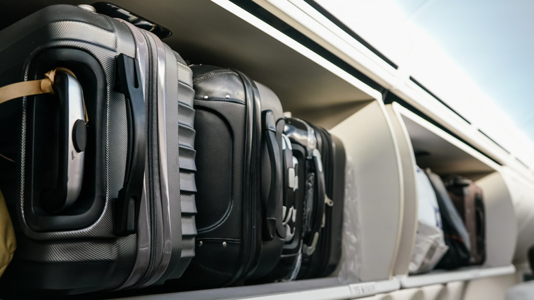 Suitcases in overhead bin on a plane