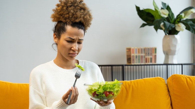 Woman checking lettuce