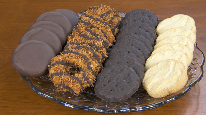 Assorted Tagalongs, Samoas, Thin Mints, and Trefoils on a plate