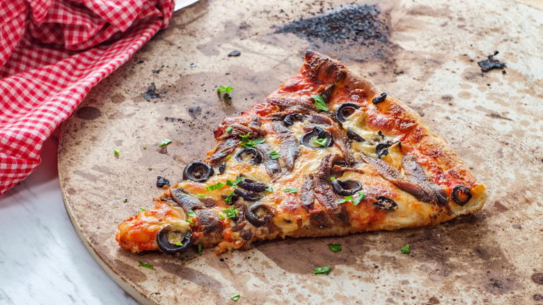 Slice of pizza on a stone