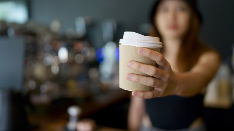 Barista handing a patron a coffee