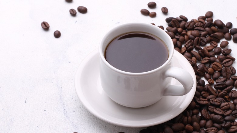 a cup of coffee and coffee beans