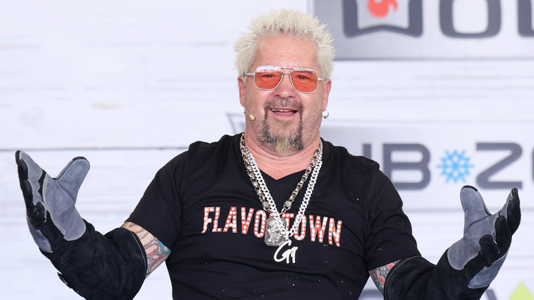 Guy Fieri with red sunglasses and a Flavortown t-shirt