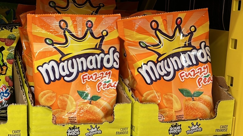 Packages of Maynards Fuzzy Peach candy in a store