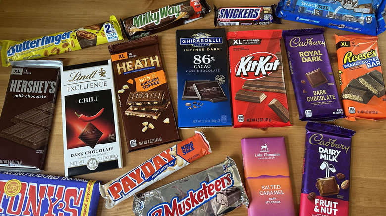 Variety of candy bars on wooden table