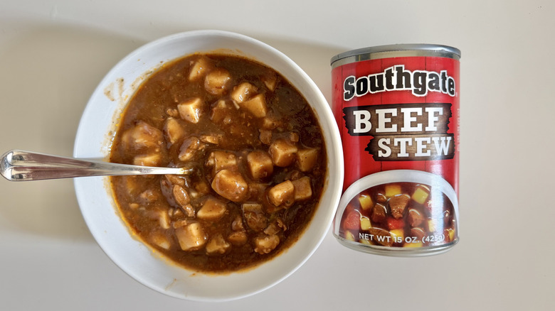 Can and bowl of Southgate beef stew on a table.