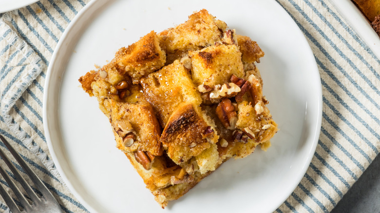 piece of cinnamon bread and pecan casserole on a white plate