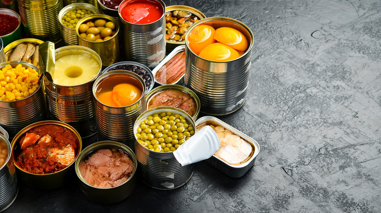 Opened canned foods gray background