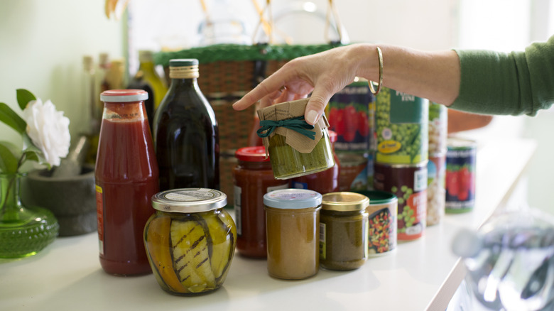Person sorting through canned foods