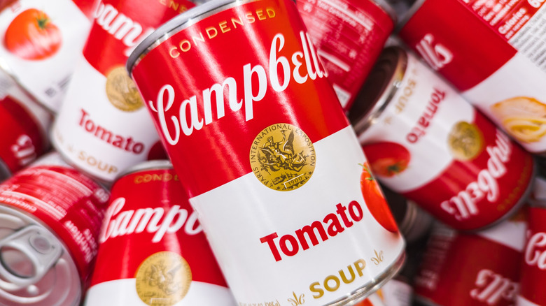 Tomato soup cans are piled together.