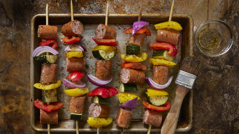 A tray of sausage kebabs