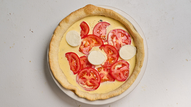 quiche topped with cheese and tomato