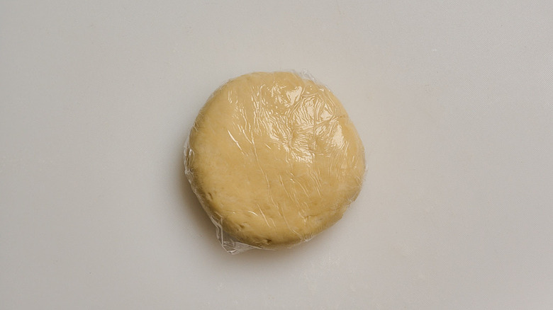 dough pressed into a disc and wrapped in plastic