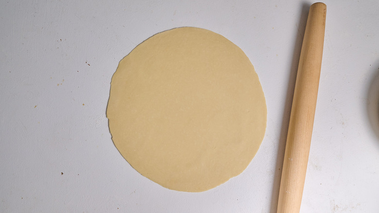 rolling dough out with a rolling pin