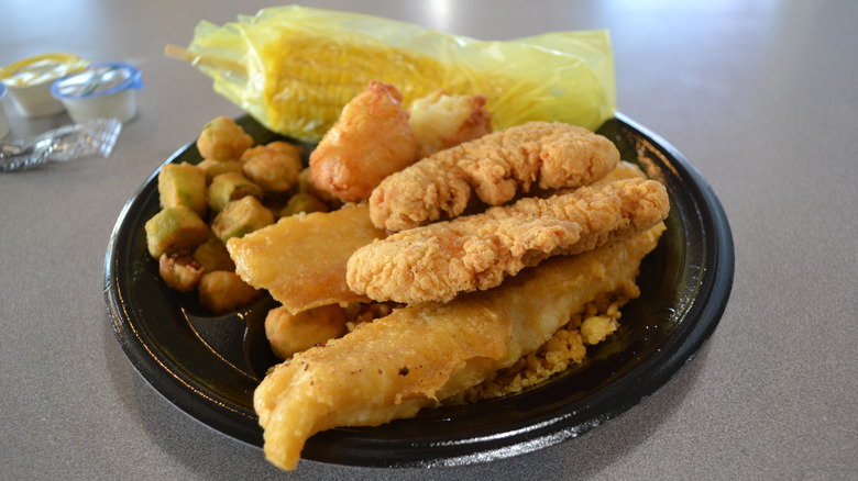 Captain D's fish and chicken combo on a black plate