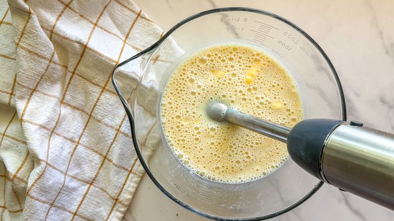blending pudding in bowl with immersion blender
