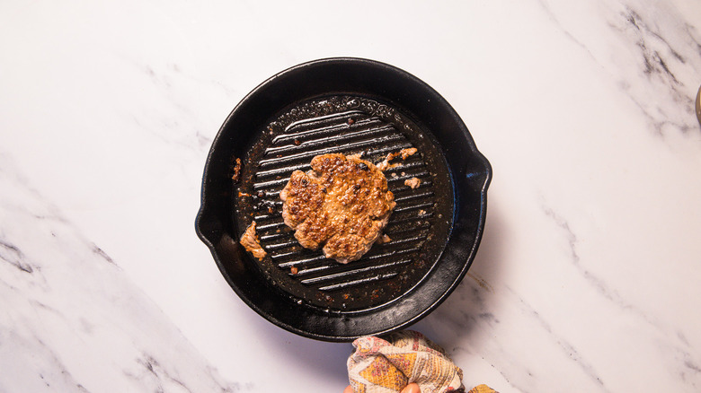 Cooked patty in cast iron pan