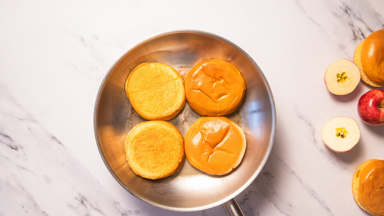 Brioche buns cooking in pan