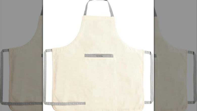 Cream-colored apron with gray straps on a white background.