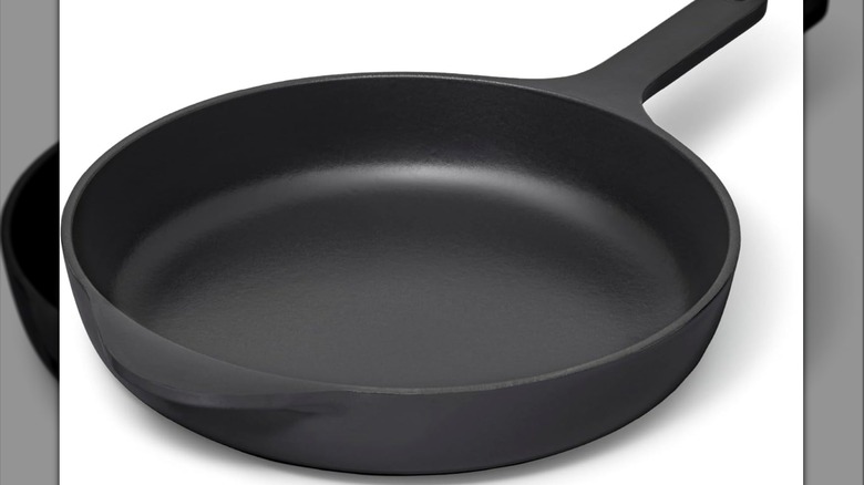 Black cast iron pan on a white background