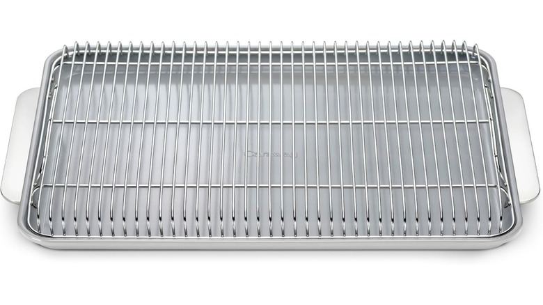 Silver baking sheet and cooling rack on a white background.