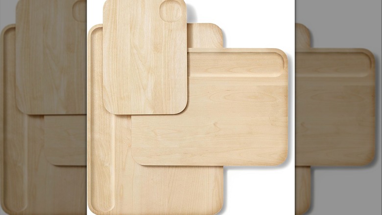 Three different sizes of wooden cutting boards stacked on top of each other.