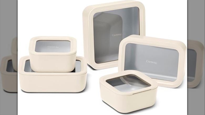 Five different sizes of cream-colored glass-top storage containers on a white background.