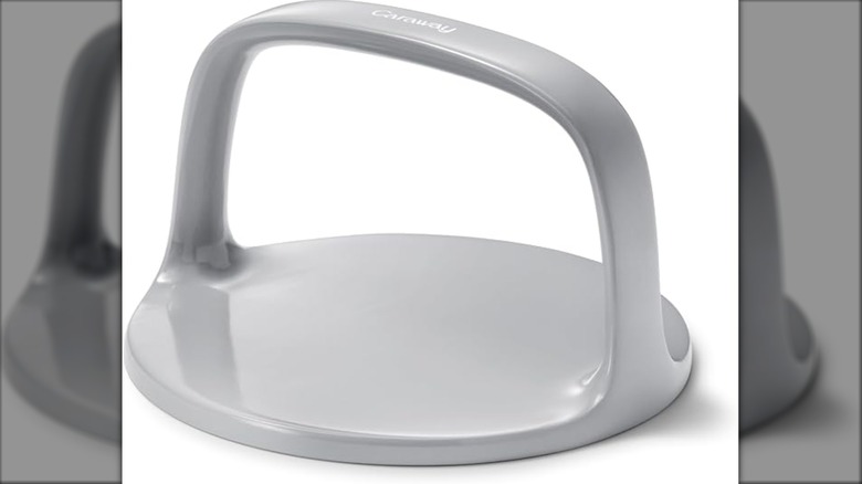Grey grill press on a white background.