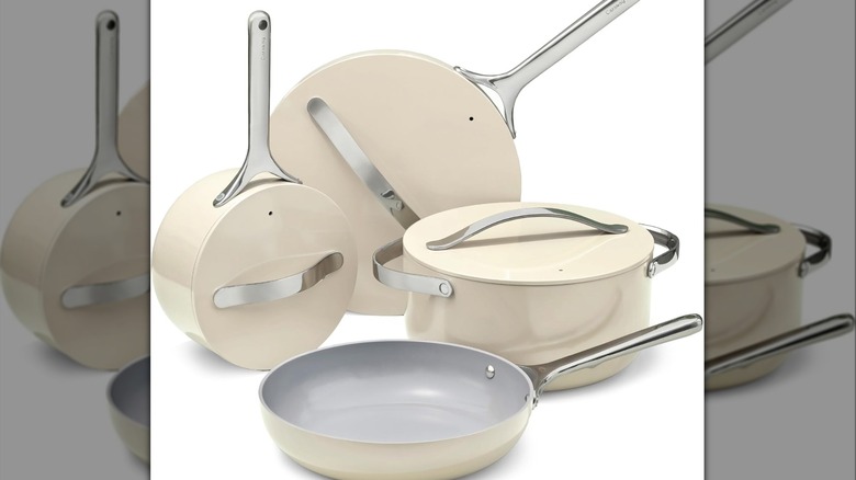 Four different cream-colored pots and pans with accompanying lids.