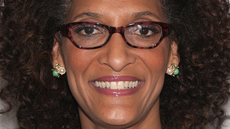 Carla Hall smiles with glasses
