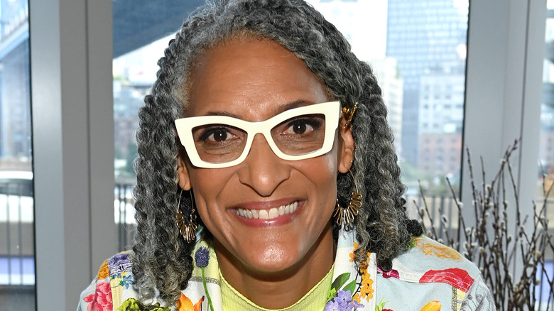 Carla Hall with white framed glasses