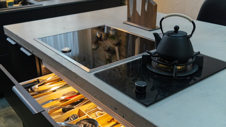 A modern-looking kitchen with a concrete countertop