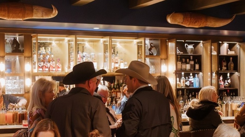 men in cowboy hats standing at bar inside Cattlemen's in Paso Robles, California