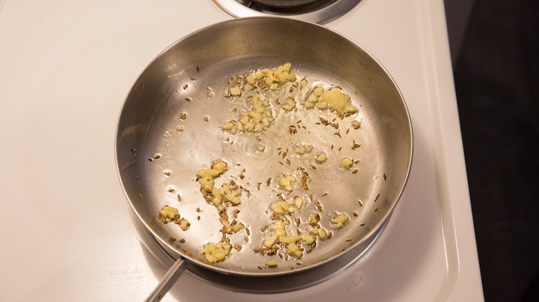 ginger sauteing in frying pan