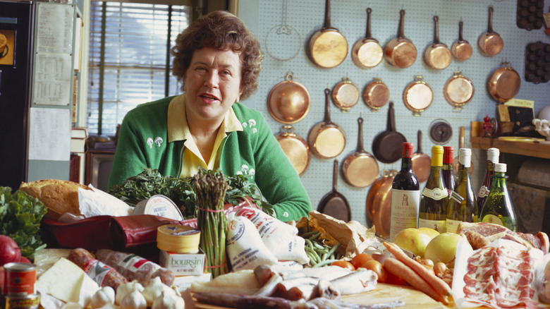 Julia Child standing in kitchen