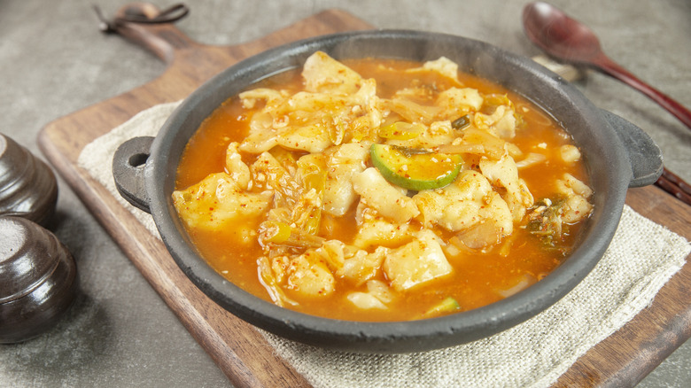 Bowl of soup with subjebi and veggies in a black bowl