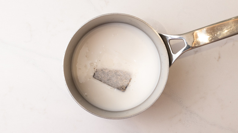teabag and milk in saucepan