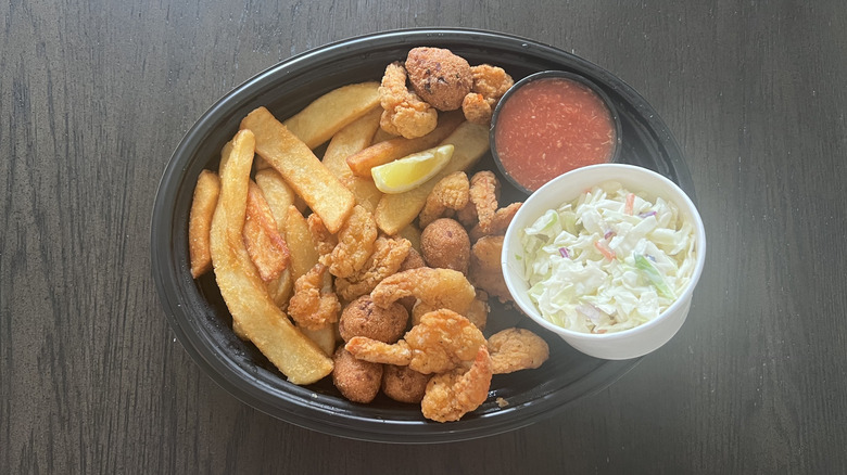 Cracker Barrel country fried shrimp with fries, coleslaw, and sauce in a to-go container