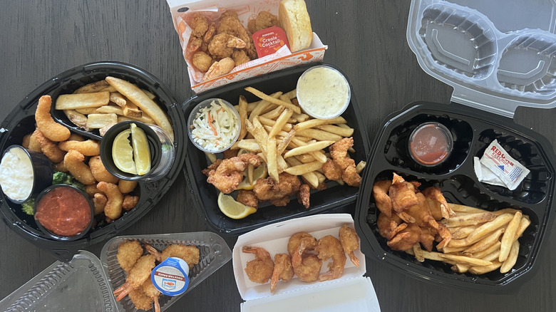 Shrimp baskets from different chain restaurants in to-go containers