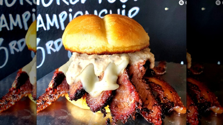 Brisket sandwich with sauces on stainless steel table