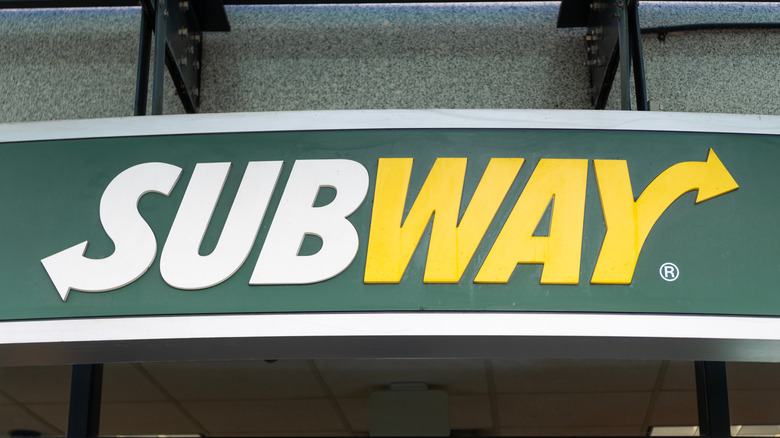 Green and yellow Subway sign on building
