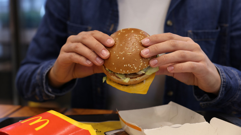 A customer eating a burger at McDonald's