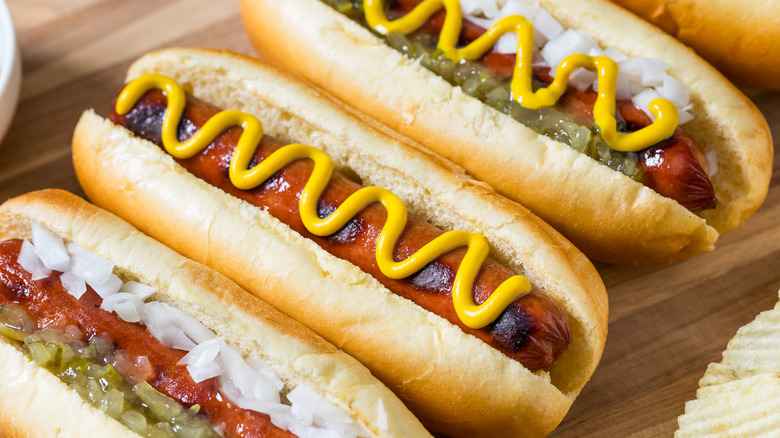 Hot dogs on a board with chips