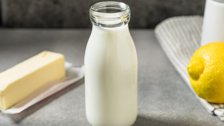 A bottle of buttermilk sits on a counter.