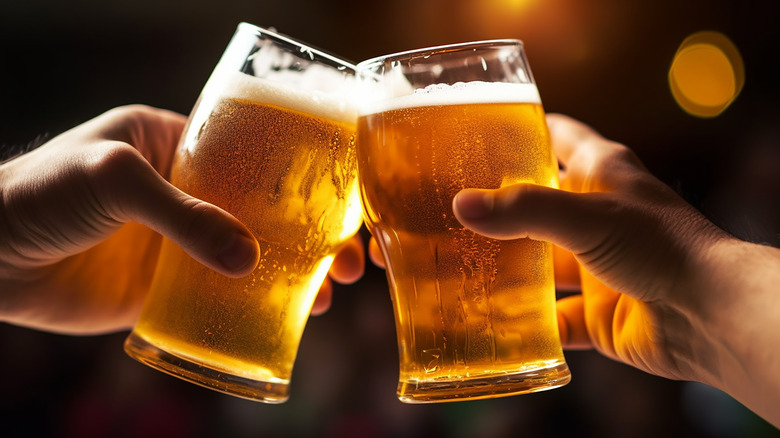 People clinking glasses of beer