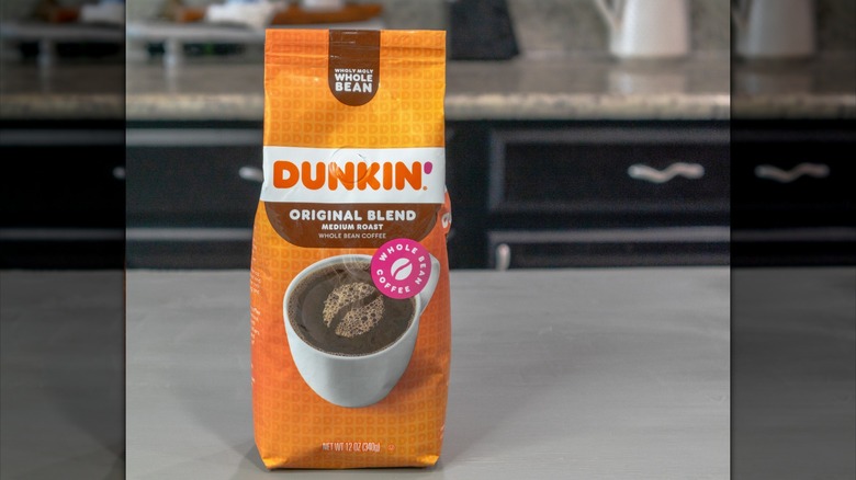 Orange bag of Dunkin' original blend on grey background