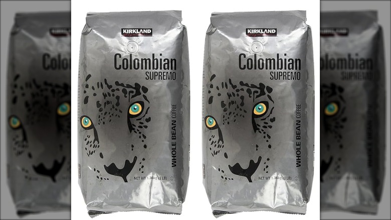 Two silver bags of Kirkland Signature Colombian supremo beans isolated o nwhite background